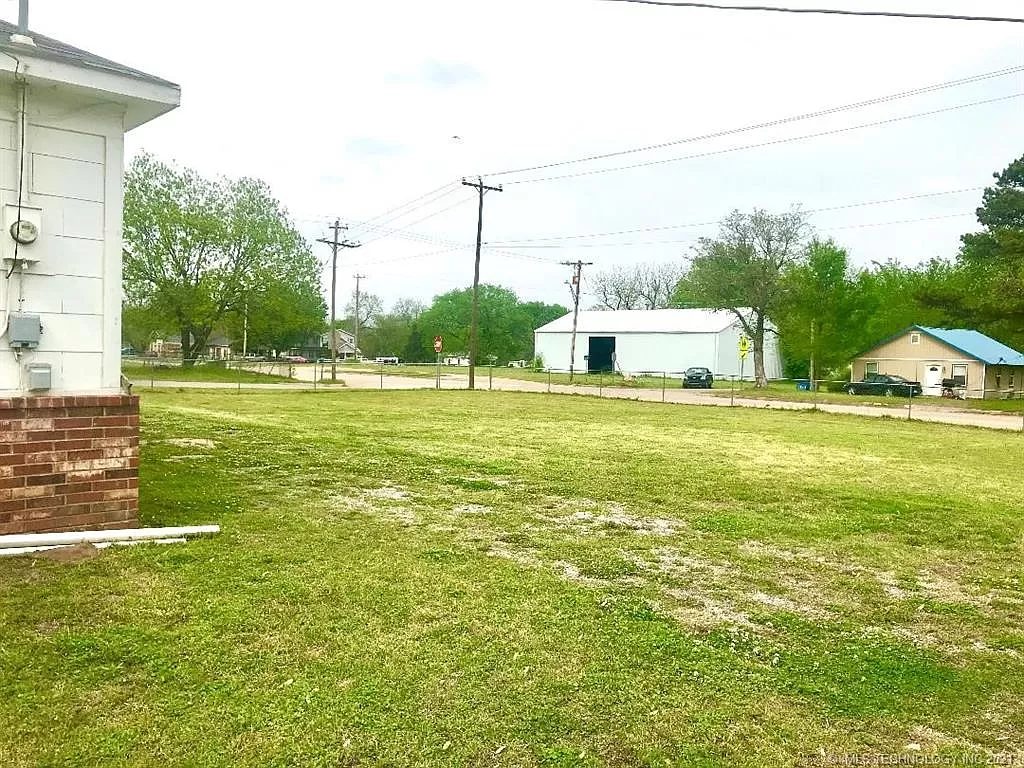 The corner lot looking across the yard, with the detached garage at the right. Spring 2021.