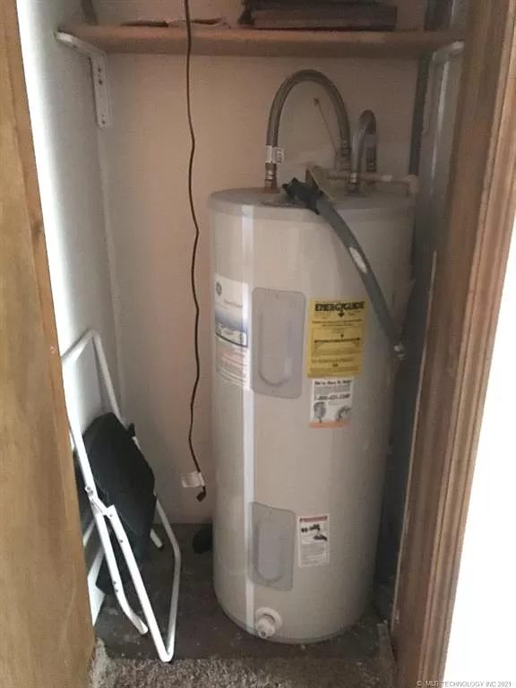 The water heater in its interior closet, 2021. No flue and no gas line — it is electric. The data plate has never been photographed.