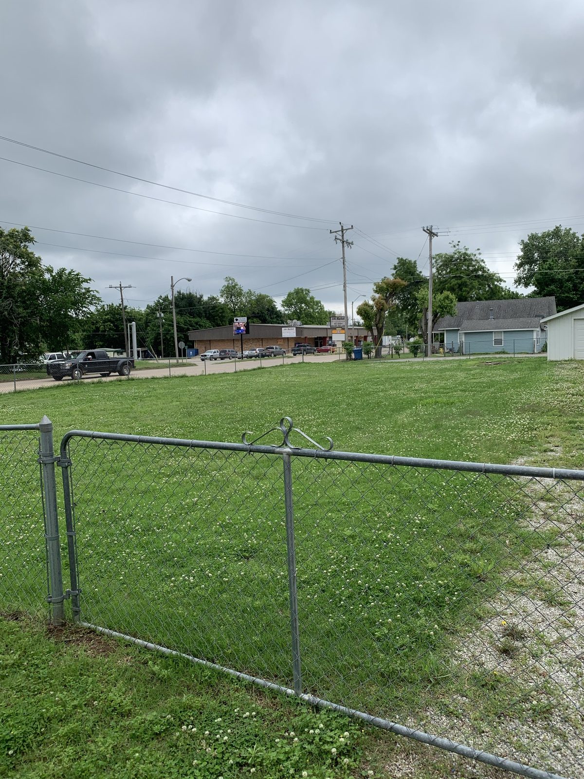 Chain link and the swing gate on the street side of the lot, 2021.